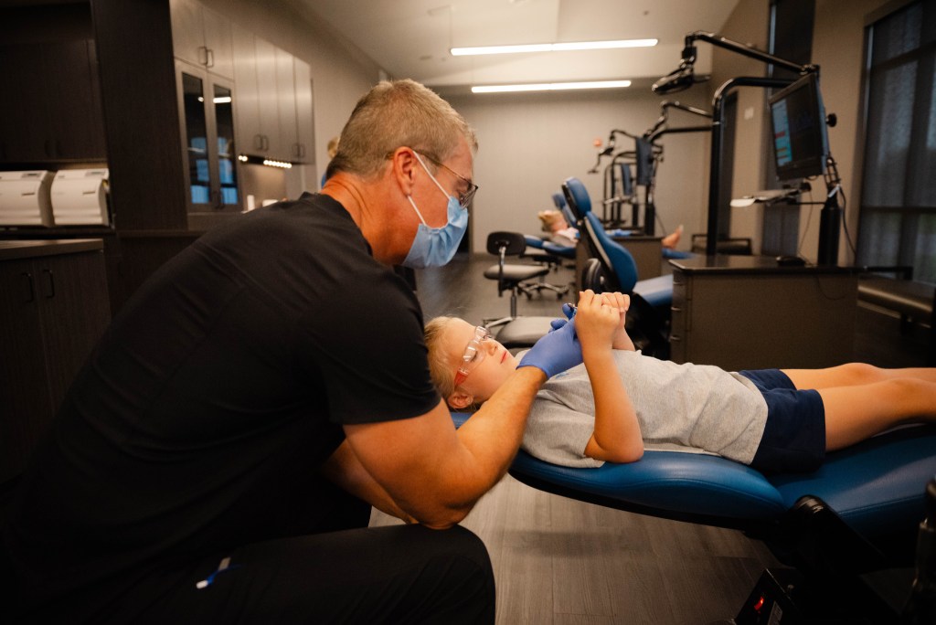 Doctor with young patient in chair